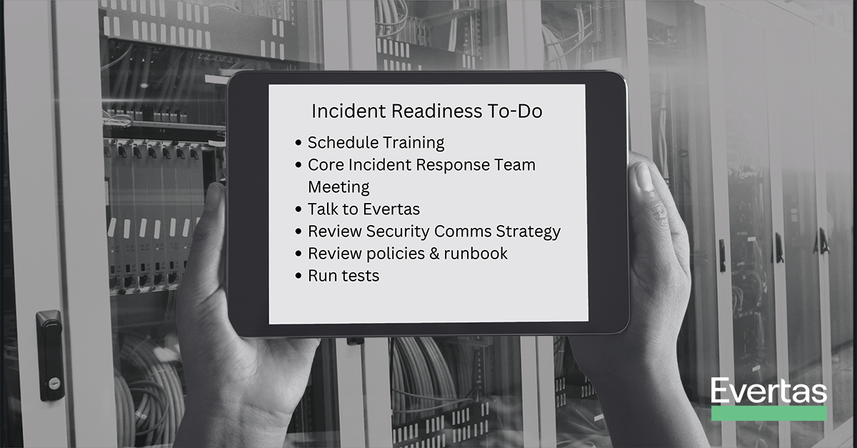 hands hold an iPad with an incident readiness checklist in a server room